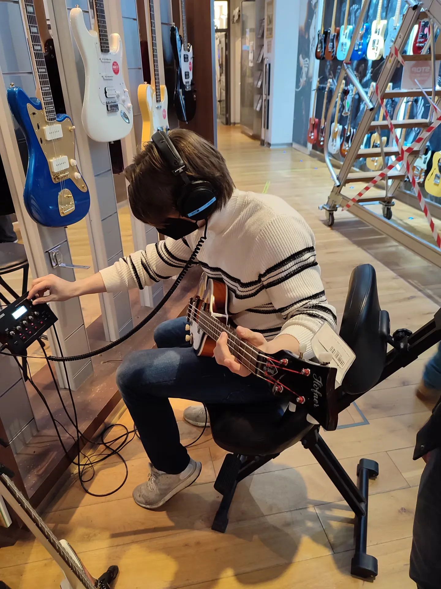 Bassed beim Stöbern im Gitarrengeschäft